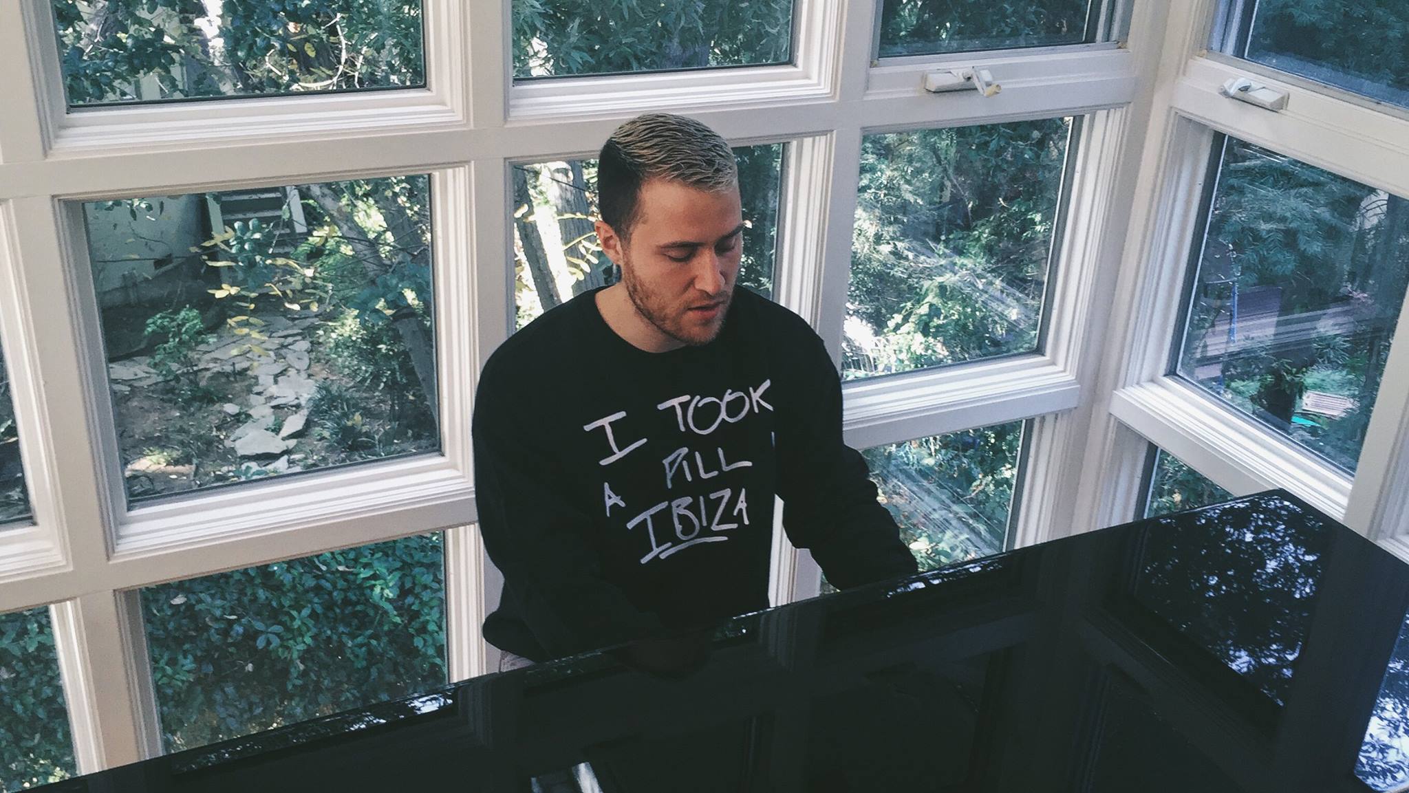 Mike Posner wearing his "I Took A Pill In Ibiza" limited edition charity sweatshirt in black

